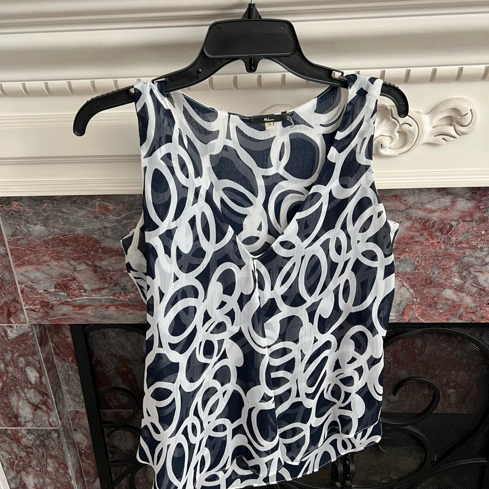 Great top for work or with jeans. Material flows so it’s great and fig flat